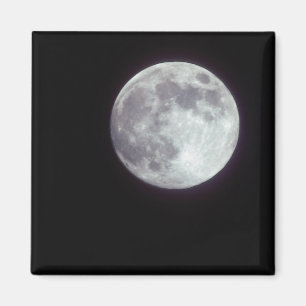 A bright full moon in a black night sky. magnet