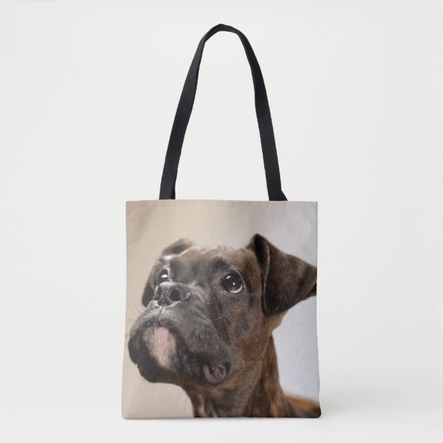 A Brindle Boxer puppy looking up curiously. Tote Bag (Front)