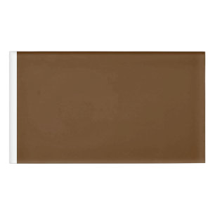 a brown background with a white border_ name tag