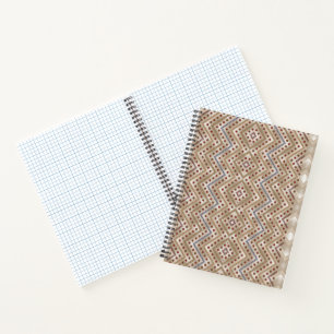 A brown rug displaying a symmetrical design featur notebook