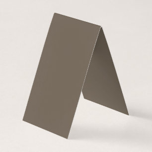 a brown wall with a black and white clock on it business card