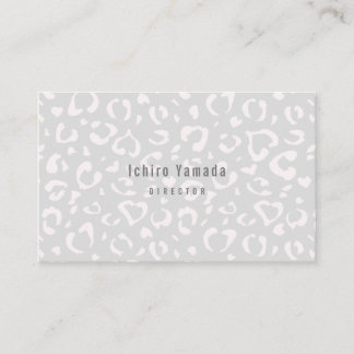 a business card with a white leopard pattern