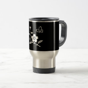 A butterfly in the middle of a cherry tree travel mug