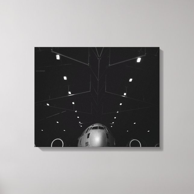 A C-17 Globemaster III sits in a hangar Canvas Print (Front)