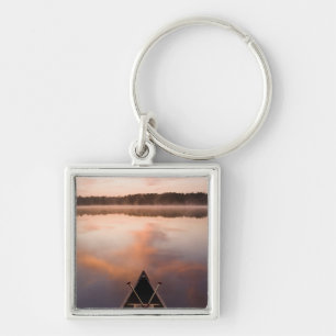A canoe rests on the shore of Pawtuckaway Lake Key Ring