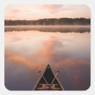 A canoe rests on the shore of Pawtuckaway Lake Square Sticker