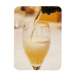 A champagne glass flute being filled with Gosset Magnet