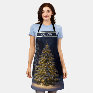 a Christmas tree is lit up in a snowy forest Apron