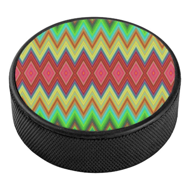A circular speaker with a vibrant, zigzag pattern hockey puck (3/4)