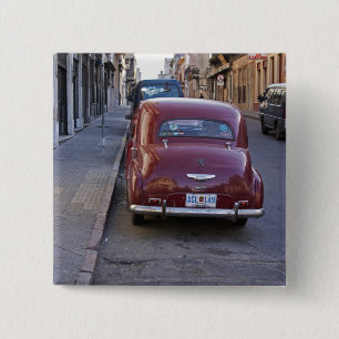 A classic old red Peugeot car parked on a street 15 Cm Square Badge