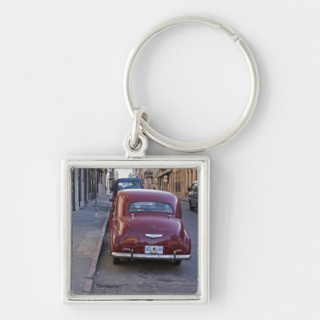 A classic old red Peugeot car parked on a street Key Ring (Front)