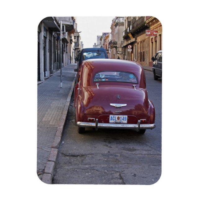 A classic old red Peugeot car parked on a street Magnet (Vertical)