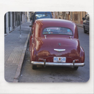 A classic old red Peugeot car parked on a street Mouse Pad