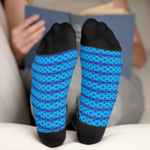 A clear blue sky stretches above a calm, deep blue socks
