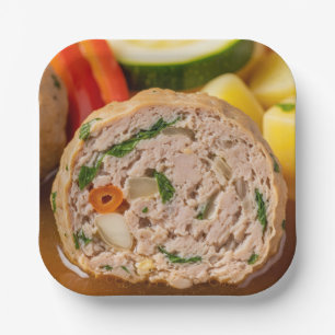 A Close-Up of a Sliced Meatball in Soup Paper Plate