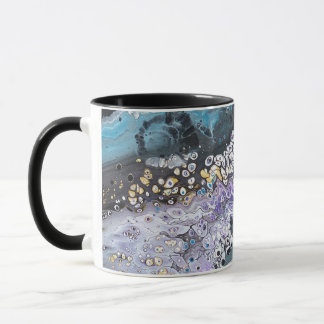 A coffee mug with purple and blue artwork
