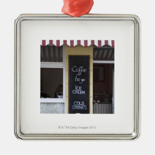 a coffee shop with a coffee to go sign metal tree decoration