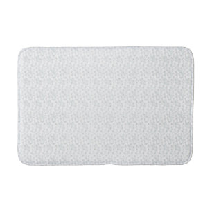 A completely white, featureless surface fills the  bath mat