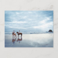 A couple riding horses on Parkiri beach in New