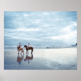 A couple riding horses on Parkiri beach in New Poster