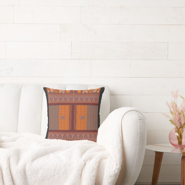 a cross stitch pattern in orange and brown cushion (Couch)