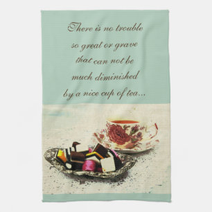 A cup of tea and sweets with quote tea towel