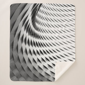 A CURVED FACADE COVERED IN WHITE LATTICEWORK SHERPA BLANKET