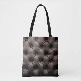 A dark leather cushion background, from a car seat tote bag