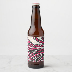 A decorative paisley design with vivid red and pin beer bottle label