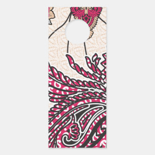 A decorative paisley design with vivid red and pin door hanger