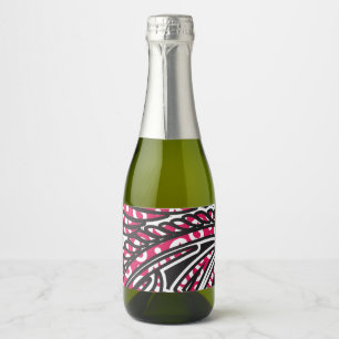 A decorative paisley design with vivid red and pin sparkling wine label