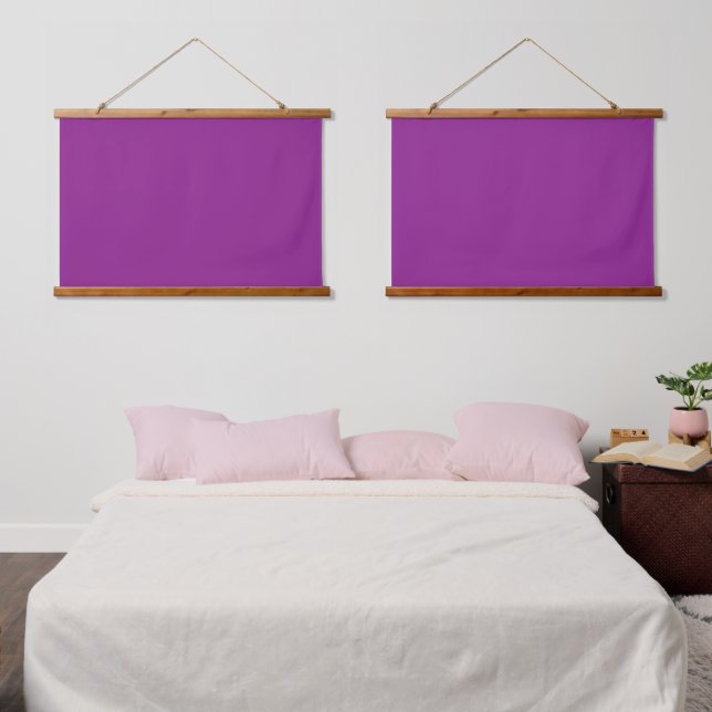 A deep purple background accented by a bright whit hanging tapestry (Bedroom)