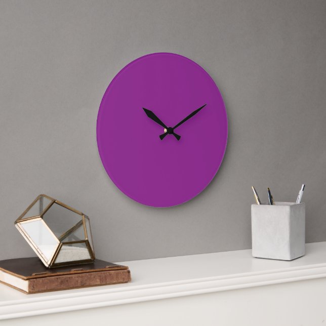 A deep purple background accented by a bright whit large clock (Office)