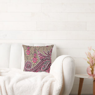 a design of a pink and brown paisley pattern cushion