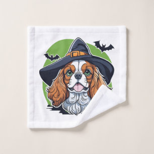 A dog wearing a witches hat with bats wash cloth