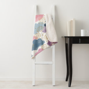 A dreamy watercolor clouds sherpa blanket