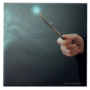 A fantasy wizard making magic with wand. tile