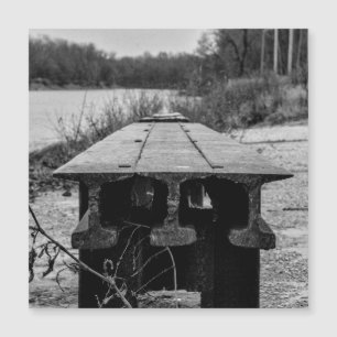 A forgotten old rail seat along a river.