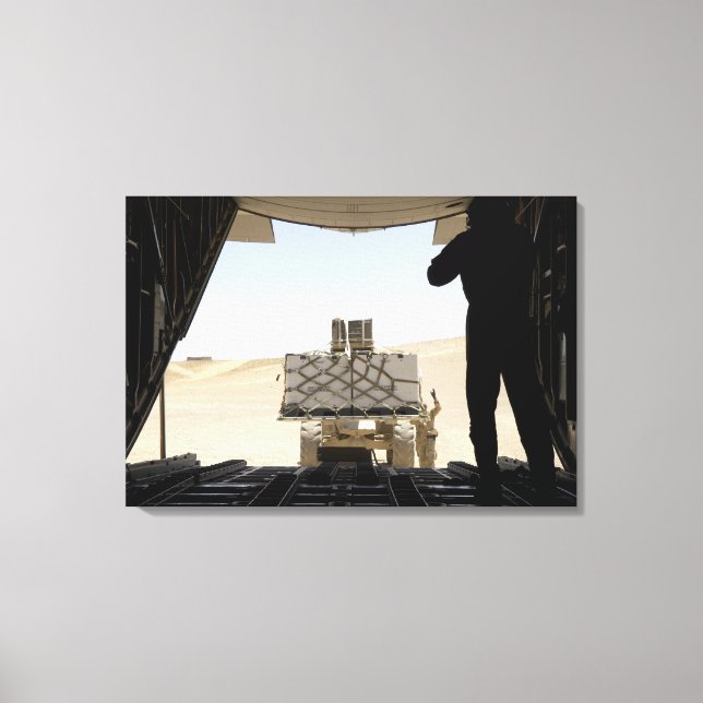 A forklift loads cargo onto a C-130 Hercules Canvas Print (Front)