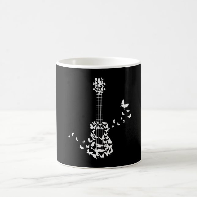 A Four String Ukulele Instrument With Beautiful Coffee Mug (Center)