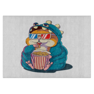 A funny hamster wearing glasses eats popcorn cutting board