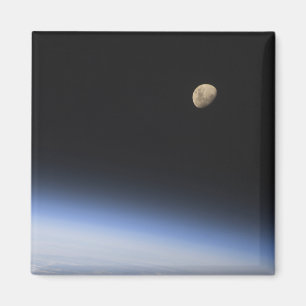 A gibbous moon visible above Earth's atmosphere Magnet