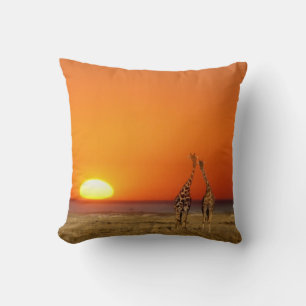 A Giraffe couple walks into the sunset, in Cushion