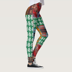 a green and black pattern with a tree in the middl leggings
