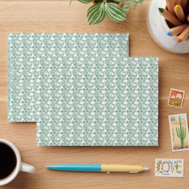 a green and white background with a pattern envelope (Desk)