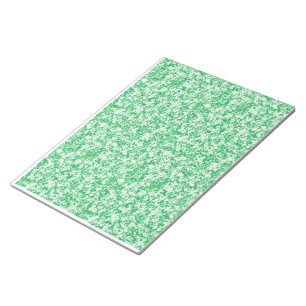 a green and white background with small white dots notepad