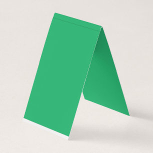 a green background with a white border business card