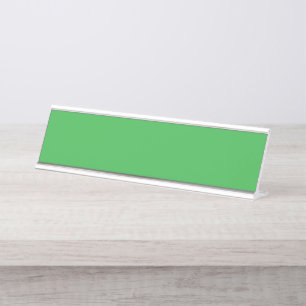 a green background with a white border desk name plate