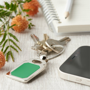 a green background with a white border key ring