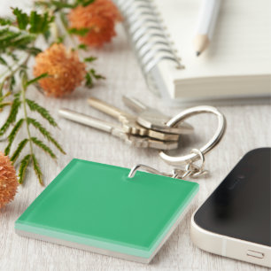 a green background with a white border key ring